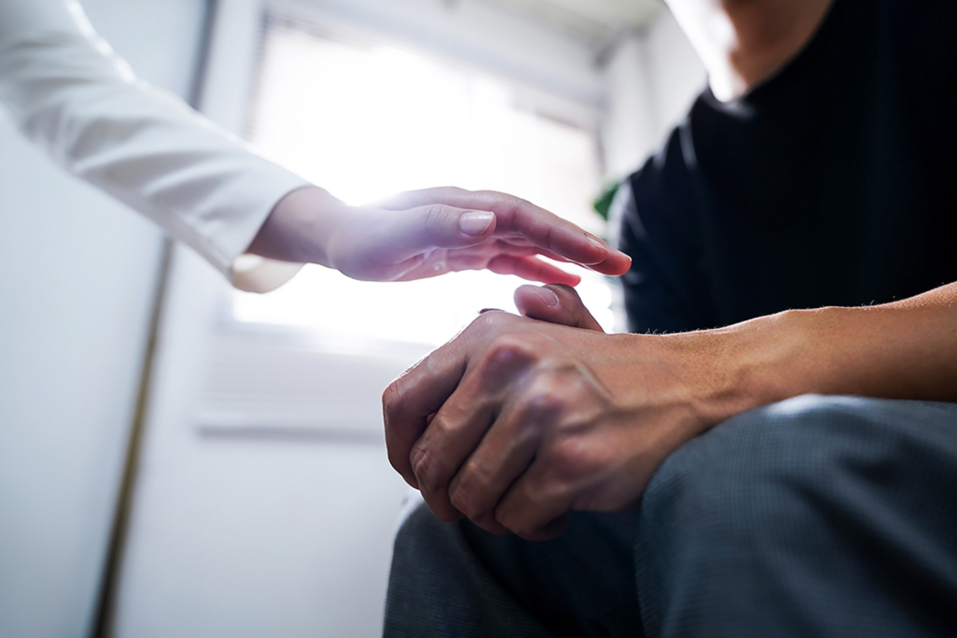 Close up of psychologist sitting and touch hand young depressed asian man for encouragement, PTSD Mental health concept.